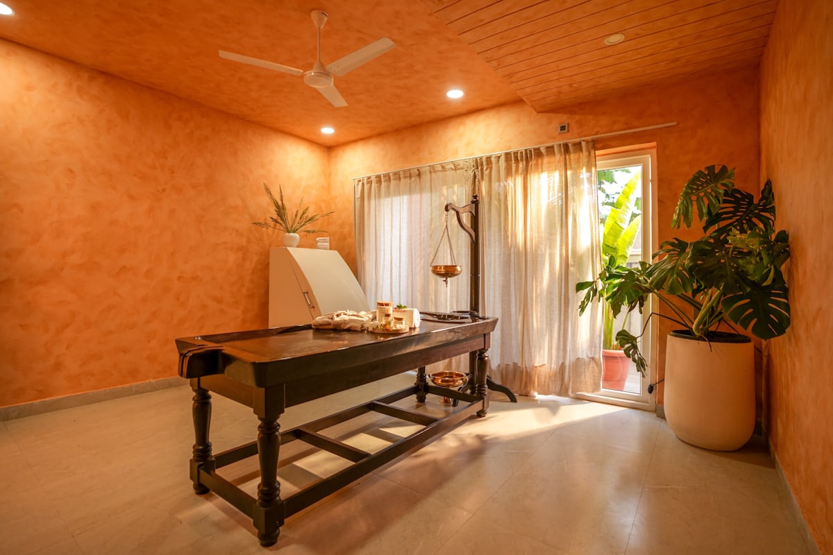 An empty, professionally prepared in-studio massage treatment room
