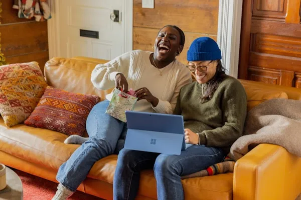 Two people browsing therapist profiles on a laptop